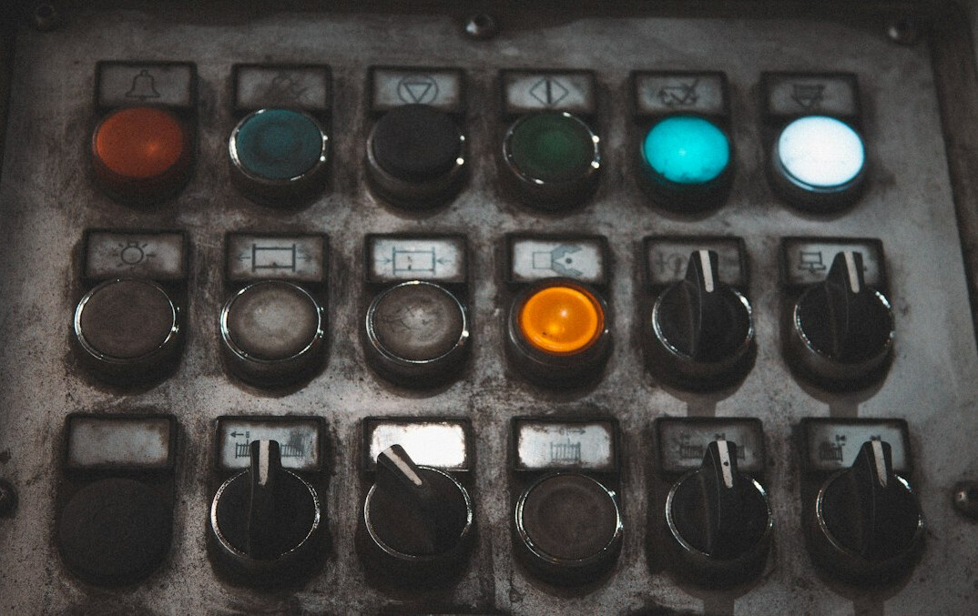Close-up of a vision mixer switcher panel with glowing buttons